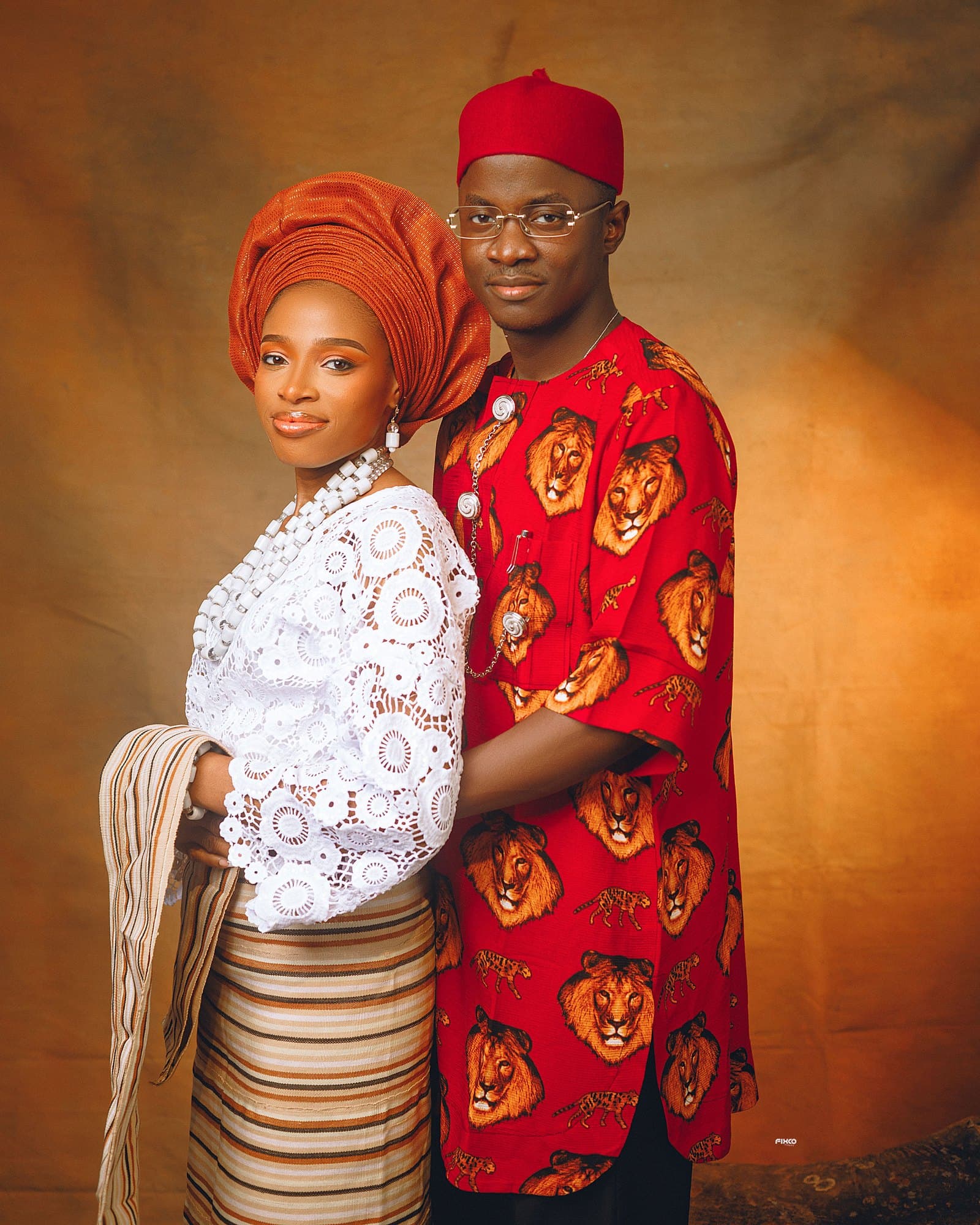 Full-length standing traditional portrait of the couple